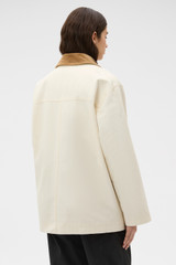 Profile view of model wearing the Oroton Cotton Chore Jacket in Calico and 100% cotton fabric for Women .