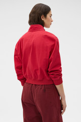 Profile view of model wearing the Oroton Knit Trim Bomber in Cerise and 100% cotton fabric for Women .