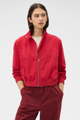 Profile view of model wearing the Oroton Knit Trim Bomber in Cerise and 100% cotton fabric for Women .