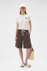 Profile view of model wearing the Oroton Maggie Graphic Tee in Calico and 100% cotton single jersey fabric for Women .