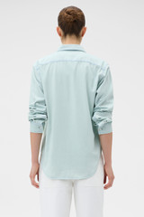 Profile view of model wearing the Oroton Chambray Shirt in Chambray and 100% cotton fabric for Women .