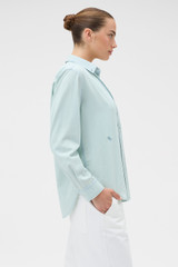 Profile view of model wearing the Oroton Chambray Shirt in Chambray and 100% cotton fabric for Women .