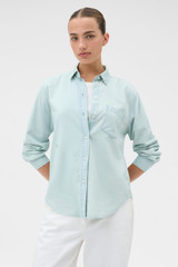 Profile view of model wearing the Oroton Chambray Shirt in Chambray and 100% cotton fabric for Women .