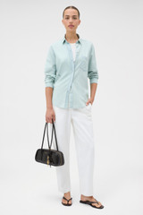 Profile view of model wearing the Oroton Chambray Shirt in Chambray and 100% cotton fabric for Women .