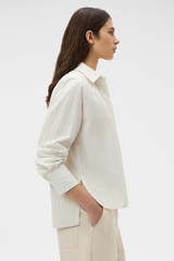 Profile view of model wearing the Oroton Placket Detail Shirt in Calico and 100% cotton fabric for Women .