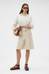 Profile view of model wearing the Oroton Placket Detail Shirt in Calico and 100% cotton fabric for Women .
