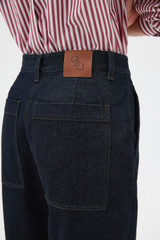 Profile view of model wearing the Oroton Denim Pant in Dark Blue and 90% cotton and 10% polyester blend fabric for Women .