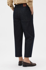 Profile view of model wearing the Oroton Denim Pant in Dark Blue and 90% cotton and 10% polyester blend fabric for Women .