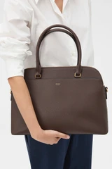 Profile view of model wearing the Oroton Iris Double Zip 14" Tote Bag in Coffee Bean and Premium pebble leather for Women .