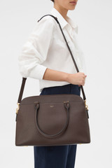 Profile view of model wearing the Oroton Iris Double Zip 14" Tote Bag in Coffee Bean and Premium pebble leather for Women .