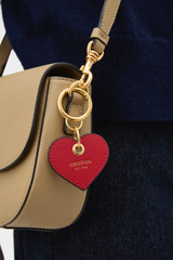 Profile view of model wearing the Oroton Harvey Small Heart Keyring in Dark Ruby and Premium smooth leather for Women .