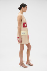 Profile view of model wearing the Oroton Patched Vintage Label Mini Dress in Nougat and 100% silk organdy fabric outer shell for Women .