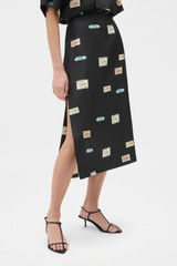 Profile view of model wearing the Oroton Vintage Label Skirt in Black and 100% silk twill fabric for Women .