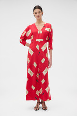 Profile view of model wearing the Oroton Vintage Label Print Dress in Market Red and 100% silk twill fabric for Women .