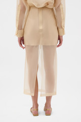Profile view of model wearing the Oroton Organdy Pencil Skirt in Nougat and 100% silk fabric for Women .