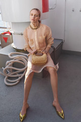 Profile view of model wearing the Oroton Organdy Pencil Skirt in Nougat and 100% silk fabric for Women .