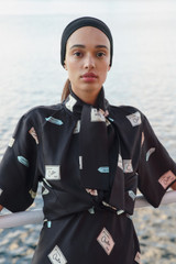 Profile view of model wearing the Oroton Vintage Label Blouse in Black and 100% silk twill fabric for Women .