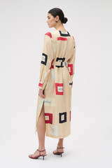 Profile view of model wearing the Oroton Vintage Label Column Dress in Nougat and 100% silk twill fabric for Women .