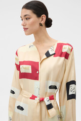 Profile view of model wearing the Oroton Vintage Label Column Dress in Nougat and 100% silk twill fabric for Women .