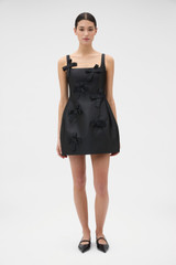 Profile view of model wearing the Oroton Bow Detail Mini Dress in Black and 85% polyester and 15% silk blend fabric for Women .