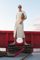 Profile view of model wearing the Oroton Button Detail Dress in Soft Cream and 100% heavyweight linen fabric for Women .