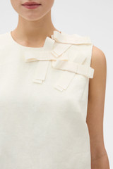 Profile view of model wearing the Oroton Bow Detail Shell in Soft Cream and 100% heavyweight linen fabric for Women .