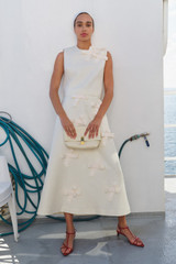 Profile view of model wearing the Oroton Bow Detail Shell in Soft Cream and 100% heavyweight linen fabric for Women .