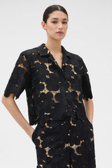 Profile view of model wearing the Oroton Poppy Lace Crop Shirt in Black and 100% polyester fabric for Women .