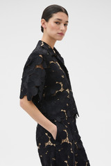 Profile view of model wearing the Oroton Poppy Lace Crop Shirt in Black and 100% polyester fabric for Women .