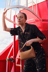 Profile view of model wearing the Oroton Poppy Lace Crop Shirt in Black and 100% polyester fabric for Women .