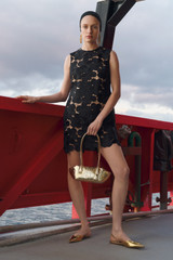Profile view of model wearing the Oroton Poppy Lace Mini Dress in Black and 100% polyester fabric for Women .