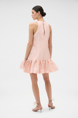 Profile view of model wearing the Oroton Halter Mini Dress in Apple Peach and 85% polyester and 15% silk blend fabric for Women .