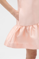 Profile view of model wearing the Oroton Halter Mini Dress in Apple Peach and 85% polyester and 15% silk blend fabric for Women .