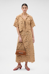 Profile view of model wearing the Oroton Poppy Lace Crop Shirt in Camel and 100% polyester fabric for Women .