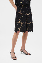 Profile view of model wearing the Oroton Poppy Lace Short in Black and 100% polyester fabric for Women .