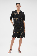 Profile view of model wearing the Oroton Poppy Lace Short in Black and 100% polyester fabric for Women .
