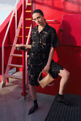 Profile view of model wearing the Oroton Poppy Lace Short in Black and 100% polyester fabric for Women .
