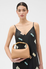 Profile view of model wearing the Oroton Winnie Small Bag in Brulee and Premium smooth leather for Women .