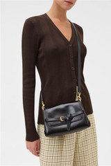 Profile view of model wearing the Oroton Margot Small Top Handle in Dark Chocolate and Premium pebble leather for Women .