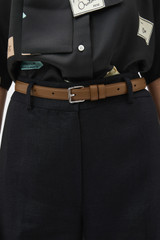 Profile view of model wearing the Oroton Florence 20MM Belt in Teak and Premium crackle leather for Women .
