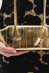 Profile view of model wearing the Oroton Breeze Baguette in Gold and Premium smooth leather for Women .