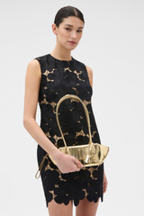 Profile view of model wearing the Oroton Breeze Baguette in Gold and Premium smooth leather for Women .