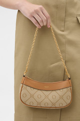 Profile view of model wearing the Oroton Harvey Signature Mini Baguette in Stone/Tan and Nylon canvas base cloth material with PVC coating (70% PVC, 30% polyester) for Women .