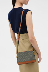 Profile view of model wearing the Oroton Harvey Signature Double Top Zip Crossbody in Black/Cognac and Nylon canvas base cloth material with PVC coating (70% PVC, 30% polyester) for Women .