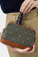 Profile view of model wearing the Oroton Harvey Signature Double Top Zip Crossbody in Black/Cognac and Nylon canvas base cloth material with PVC coating (70% PVC, 30% polyester) for Women .