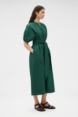 Profile view of model wearing the Oroton Grace Popover Dress in Helm Green and 100% cotton poplin fabric for Women .