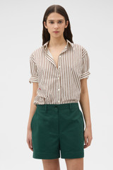 Profile view of model wearing the Oroton Alfie Carpenter Short in Helm Green and Crafted from cotton twill  for Women .