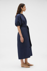 Profile view of model wearing the Oroton Grace Popover Dress in North Sea and 100% cotton poplin fabric for Women .
