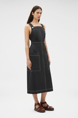 Profile view of model wearing the Oroton Pocket Detail Dress in Washed Black and 100% cotton canvas fabric for Women .