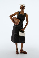Profile view of model wearing the Oroton Pocket Detail Dress in Washed Black and 100% cotton canvas fabric for Women .